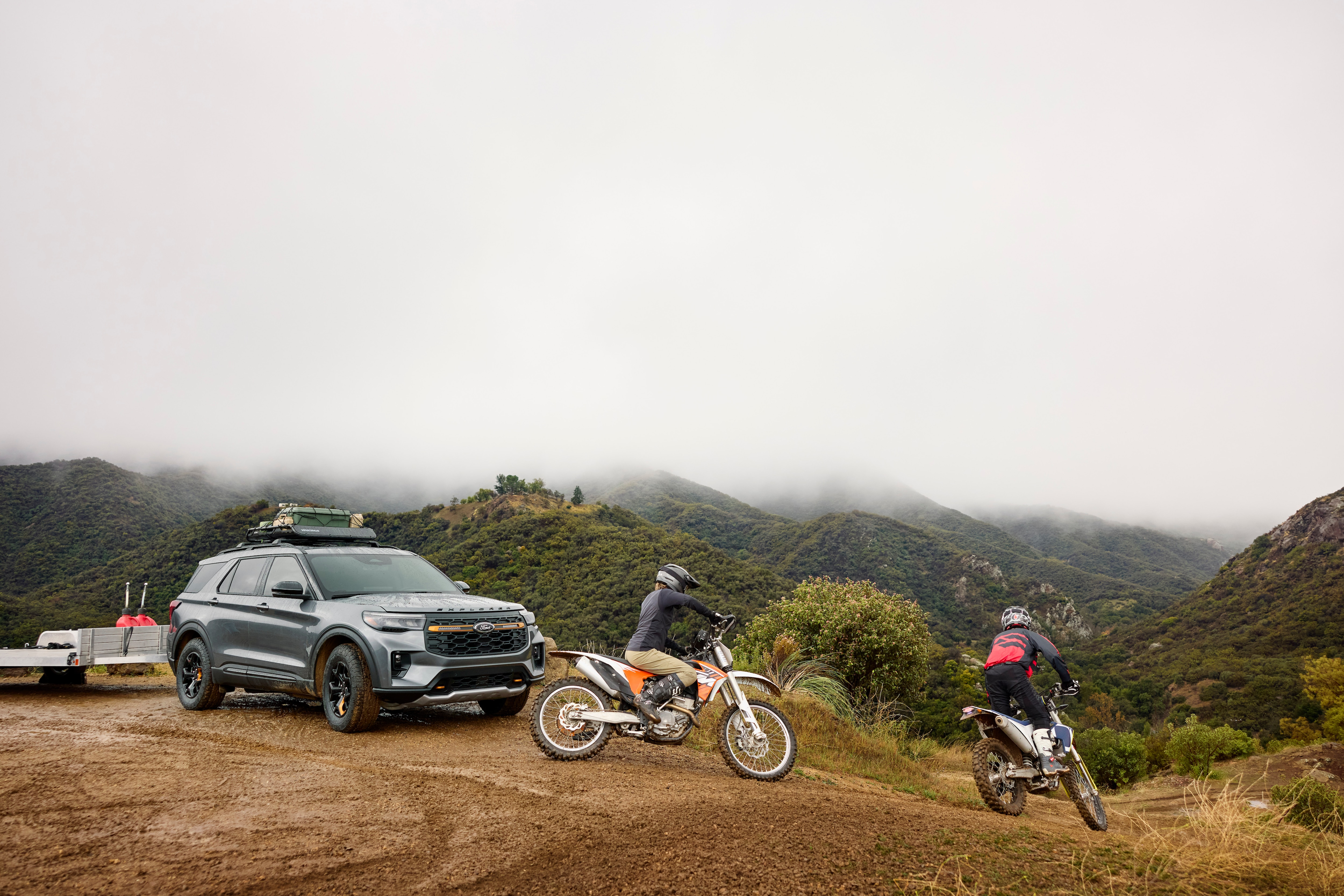 A couple riding off on their dirt bikes.